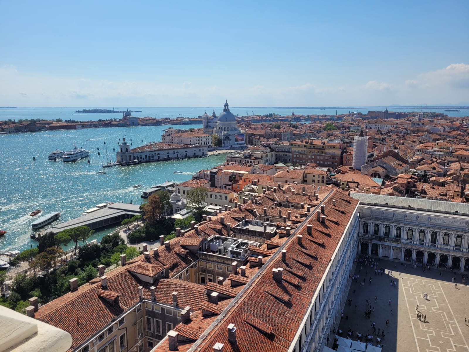 Aerial view of Venice with red-roofed buildings and a body of water - the Venice lagoon.